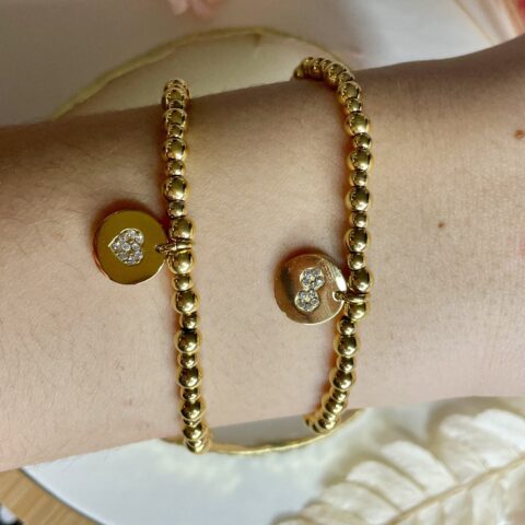 Composition bracelets Co88 France en acier inoxydable doré et pampille coeur et motif infini